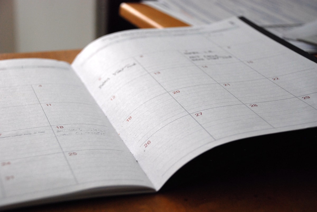 Calendar and laptop on a desk representing a web design timeline