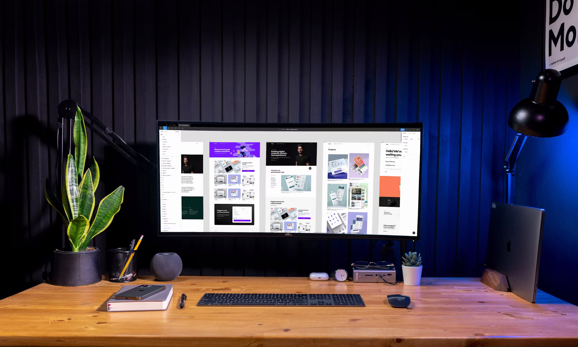 Web designer workspace with monitor showing website designs
